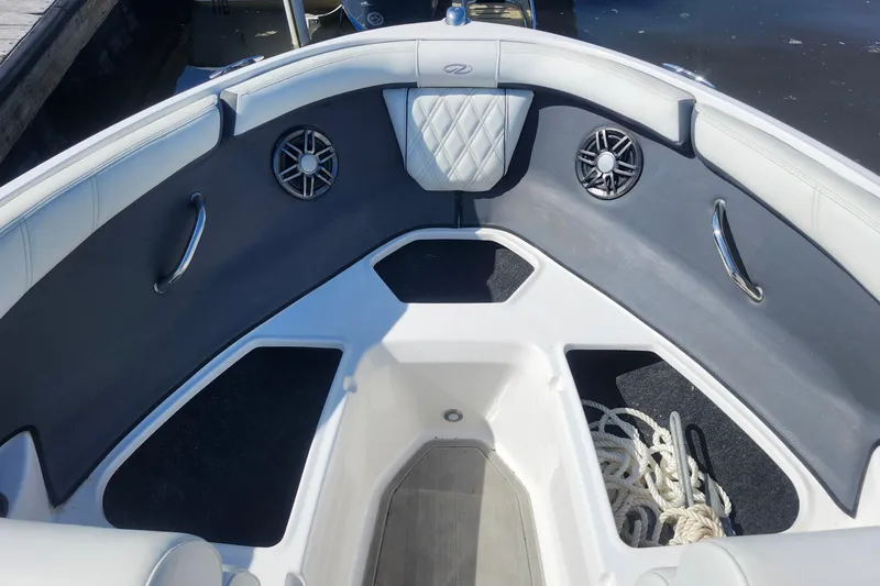 Slide: The Image of 2023 Regal 21 OBX boat interior with seating, speakers, and storage area. - 9
