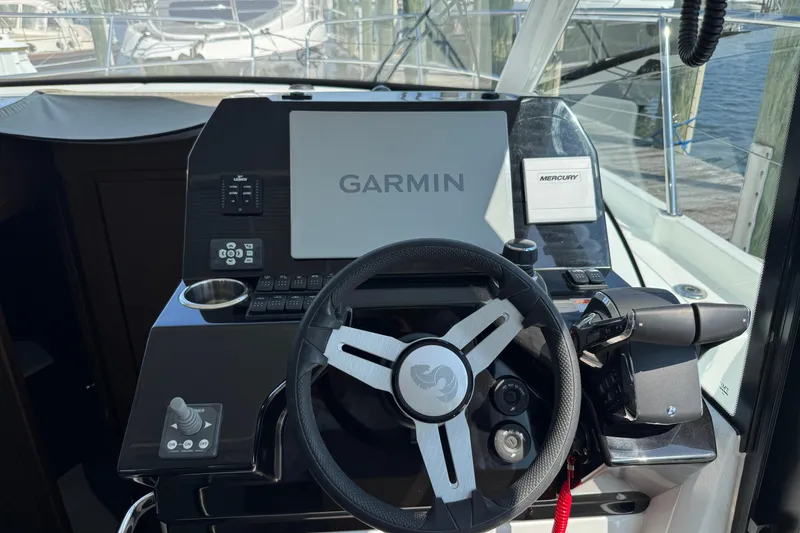 Slide: The Image of 2024 Beneteau Antares 11 helm with Garmin navigation and Mercury controls. - 12