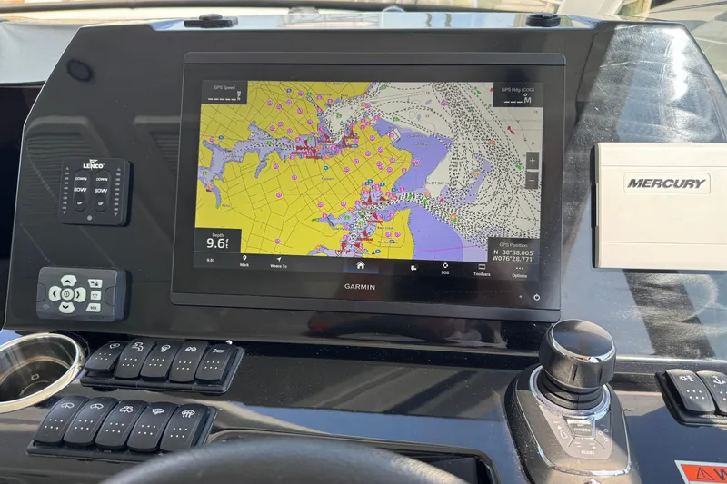 Slide: The Image of 2024 Beneteau Antares 11 dashboard with Garmin navigation display and Mercury controls. - 13