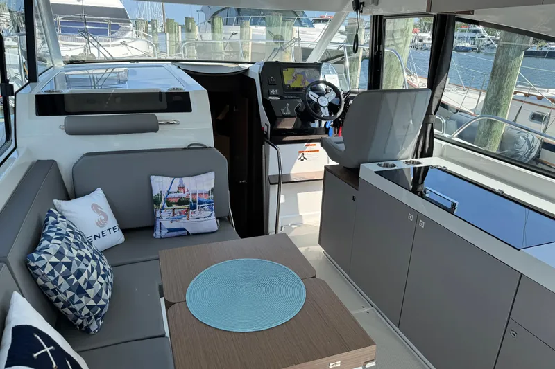 Slide: The Image of Interior of 2024 Beneteau Antares 11, featuring modern seating and navigation area. - 16