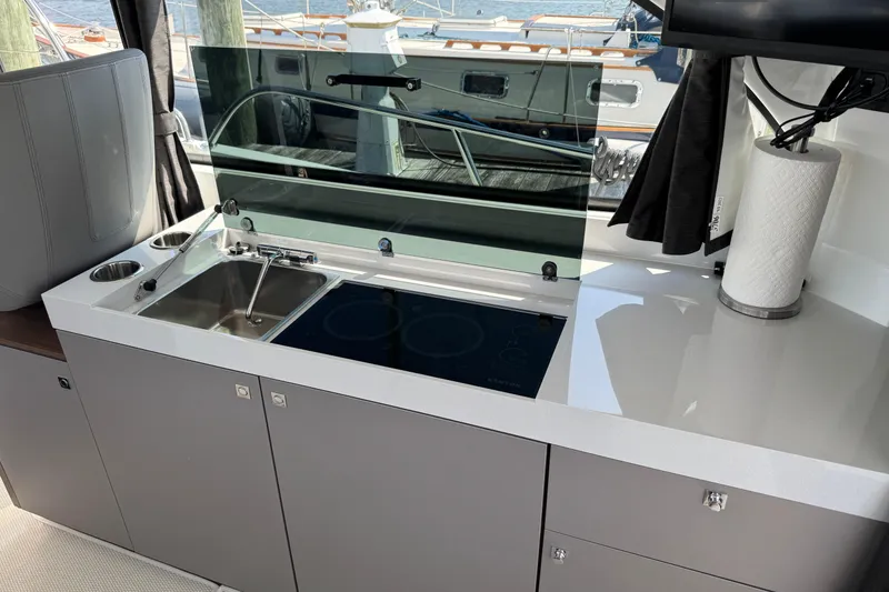Slide: The Image of Modern kitchen area on 2024 Beneteau Antares 11 boat with sink and stove. - 20