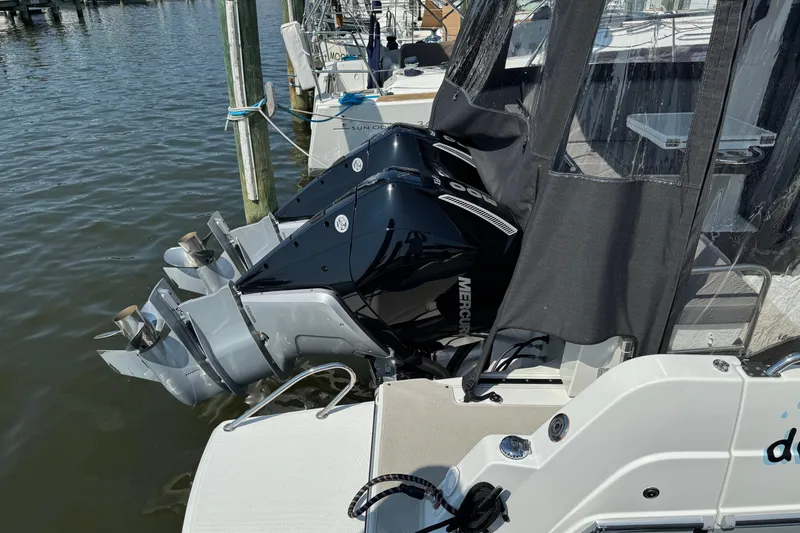 Slide: The Image of 2024 Beneteau Antares 11 with dual Mercury outboard engines docked at marina. - 6