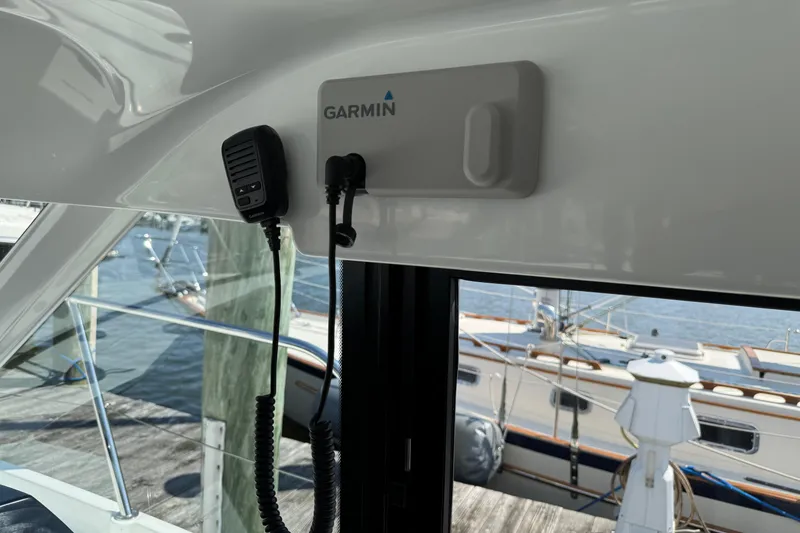 Slide: The Image of 2024 Beneteau Antares 11 interior with Garmin marine equipment and docked boats view. - 8
