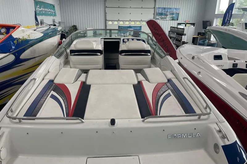 Slide: The Image of 2005 Formula 292 FASTech boat interior with colorful seating in a showroom. - 2