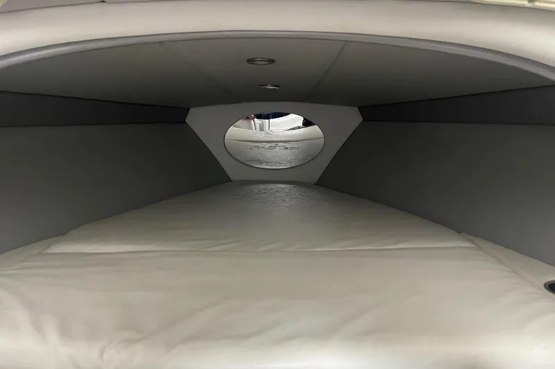 Slide: The Image of Interior cabin of a 2005 Formula 292 FASTech boat, featuring a cushioned sleeping area. - 22