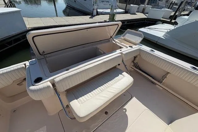 Slide: The Image of 2013 Grady-White Canyon 336 boat interior with open storage compartment and seating. - 10