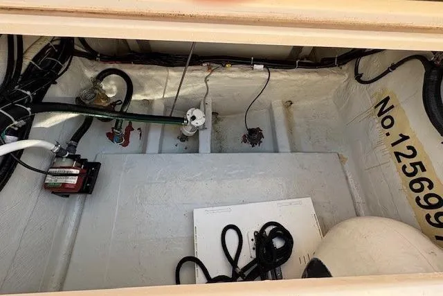 Slide: The Image of 2013 Grady-White Canyon 336 boat compartment with wiring and equipment. - 11