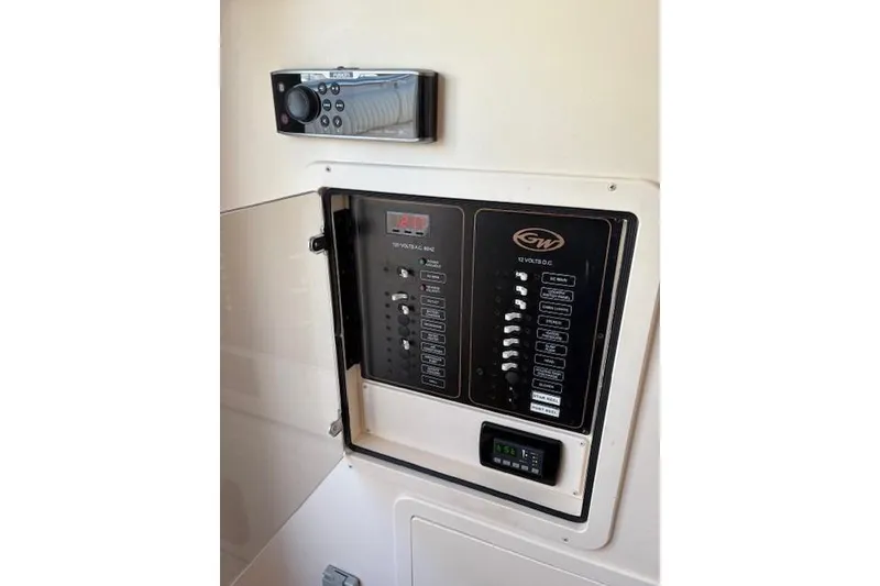 Slide: The Image of Control panel of 2013 Grady-White Canyon 336 boat, featuring switches and a stereo system. - 18