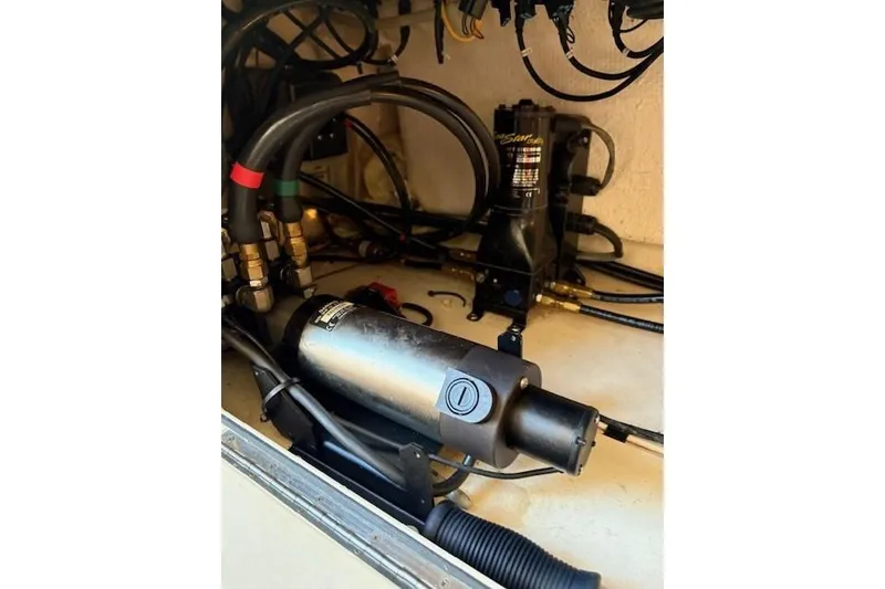 Slide: The Image of 2013 Grady-White Canyon 336 boat engine compartment with hydraulic components and wiring. - 19