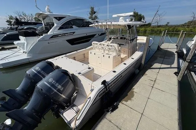 Slide: The Image of 2013 Grady-White Canyon 336 boat docked with twin Yamaha engines. - 2