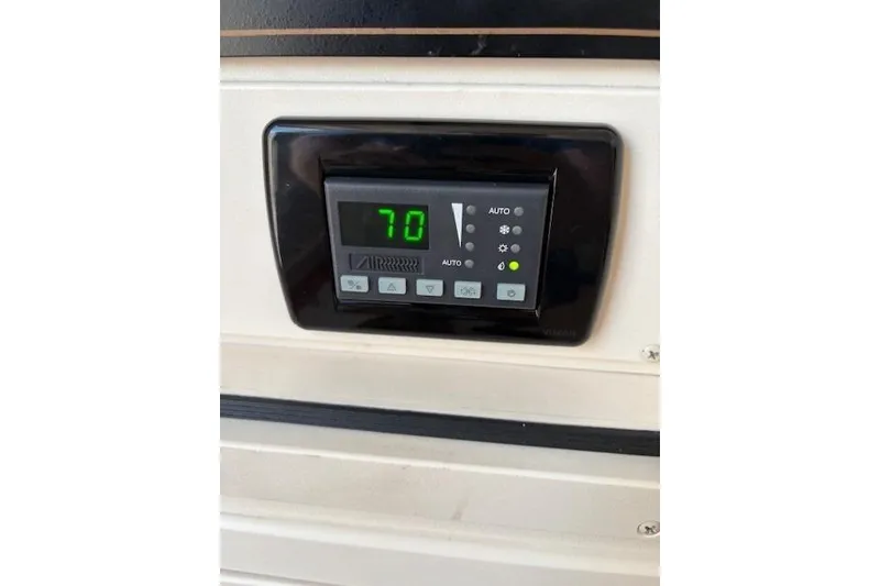 Slide: The Image of Digital control panel on 2013 Grady-White Canyon 336 boat, displaying temperature at 70 degrees. - 20