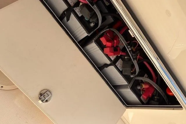 Slide: The Image of Battery compartment of a 2013 Grady-White Canyon 336 boat, showing wiring and connections. - 22