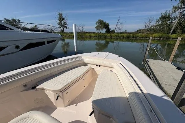 Slide: The Image of 2013 Grady-White Canyon 336 boat docked by a serene lake. - 25