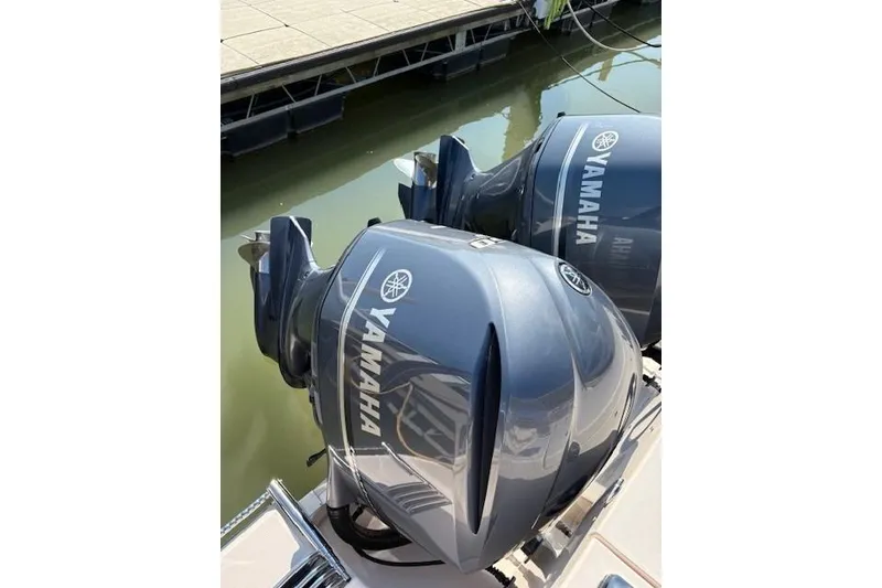 Slide: The Image of Twin Yamaha outboard engines on a 2013 Grady-White Canyon 336 boat at a dock. - 28