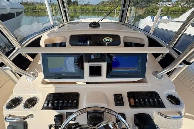 Slide: The Image of 2013 Grady-White Canyon 336 helm with dual navigation screens and control panel. - 5