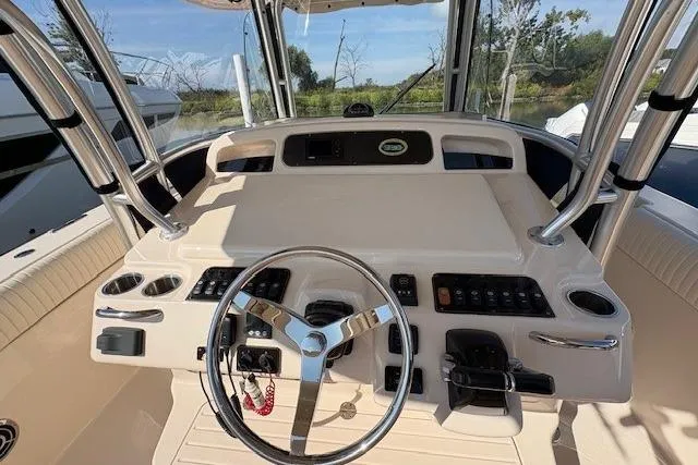 Slide: The Image of 2013 Grady-White Canyon 336 boat helm with steering wheel and control panel. - 6