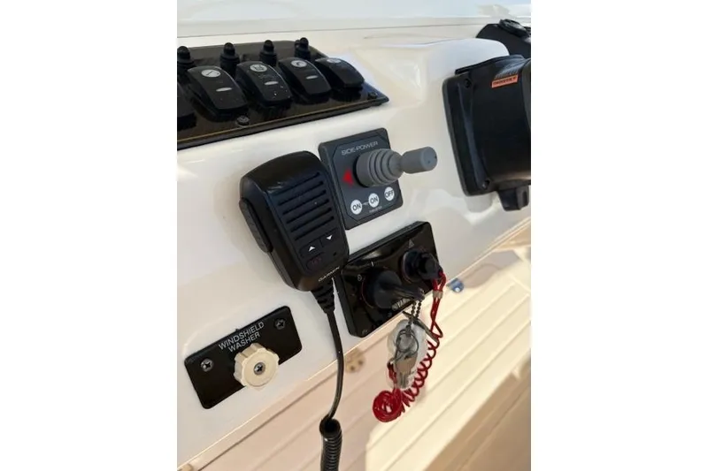 Slide: The Image of 2013 Grady-White Canyon 336 boat control panel with microphone and switches. - 7