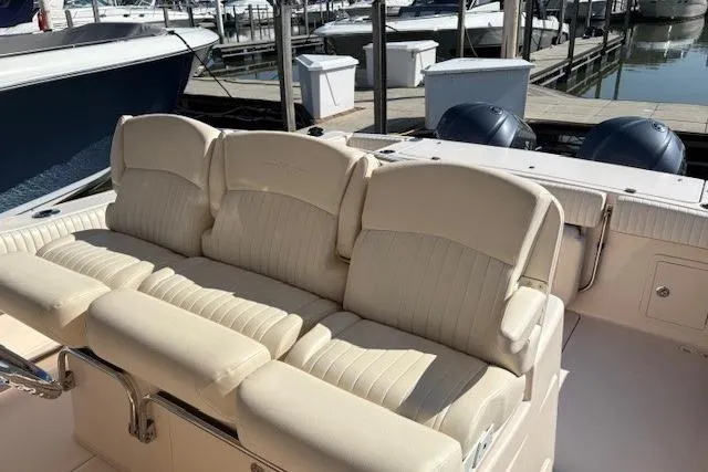 Slide: The Image of 2013 Grady-White Canyon 336 boat with beige seating at a marina. - 9