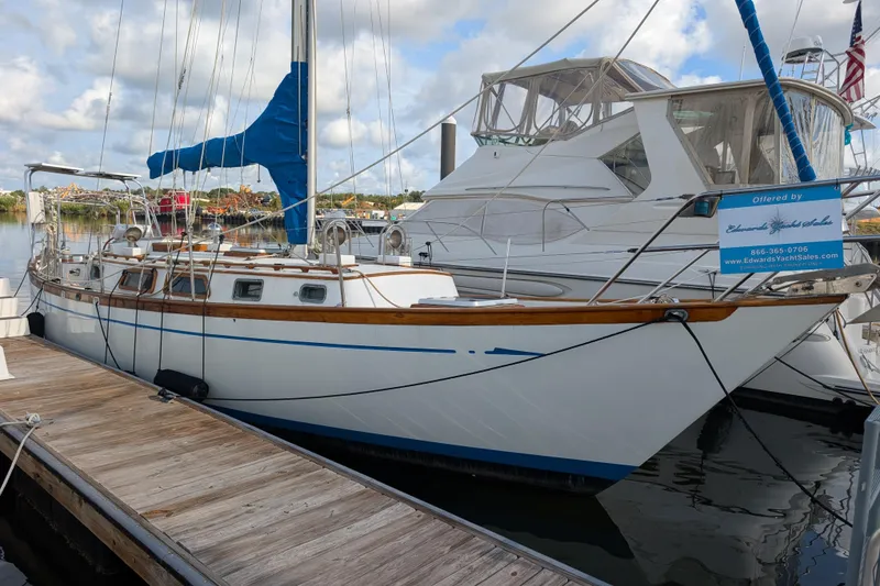 The Image of Sailboat docked at marina, Robert Perry 41 model, 1983, with blue sail cover. - 0
