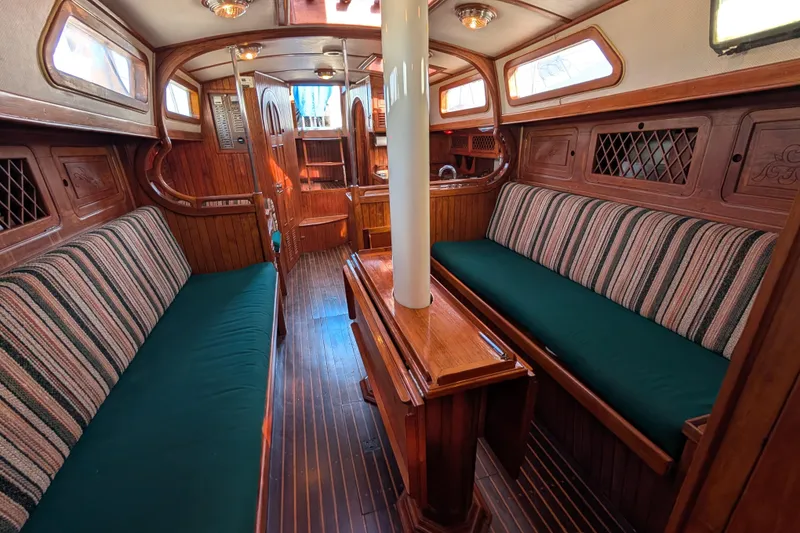 Slide: The Image of Interior of 1983 Robert Perry 41 sailboat with wooden furnishings and striped upholstery. - 10
