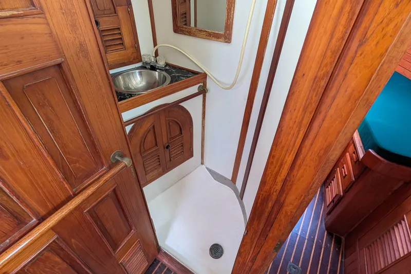 Slide: The Image of 1983 Perry 41 yacht bathroom with wooden cabinetry and compact shower area. - 11