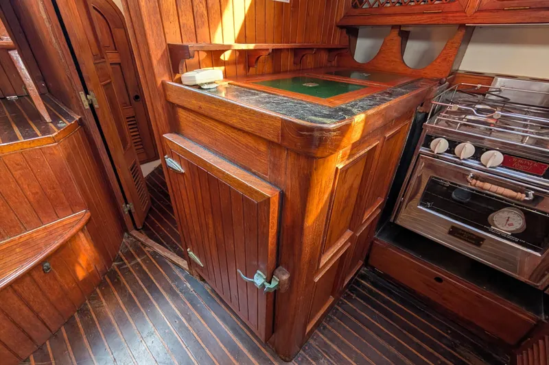 Slide: The Image of Wooden interior of 1983 Robert Perry 41 yacht with stove and cabinetry. - 18