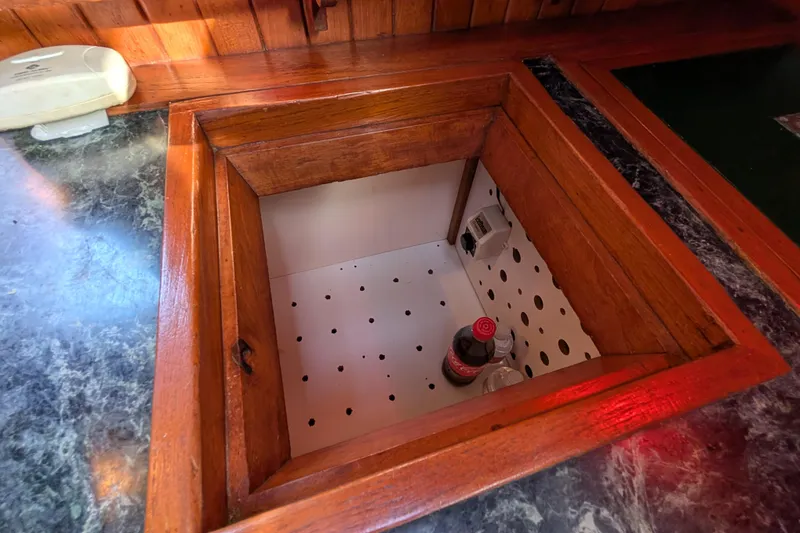 Slide: The Image of Wooden storage compartment on a 1983 Robert Perry 41 yacht, containing drinks. - 20