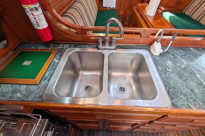 Slide: The Image of Stainless steel double sink in 1983 Robert Perry 41 yacht kitchen, with marble countertop. - 24