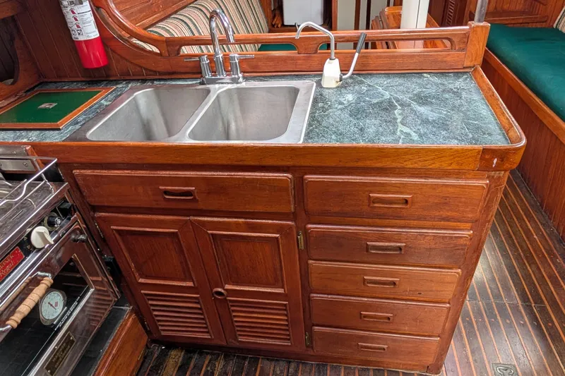 Slide: The Image of Wooden kitchen galley with double sink in 1983 Perry 41 yacht. - 25