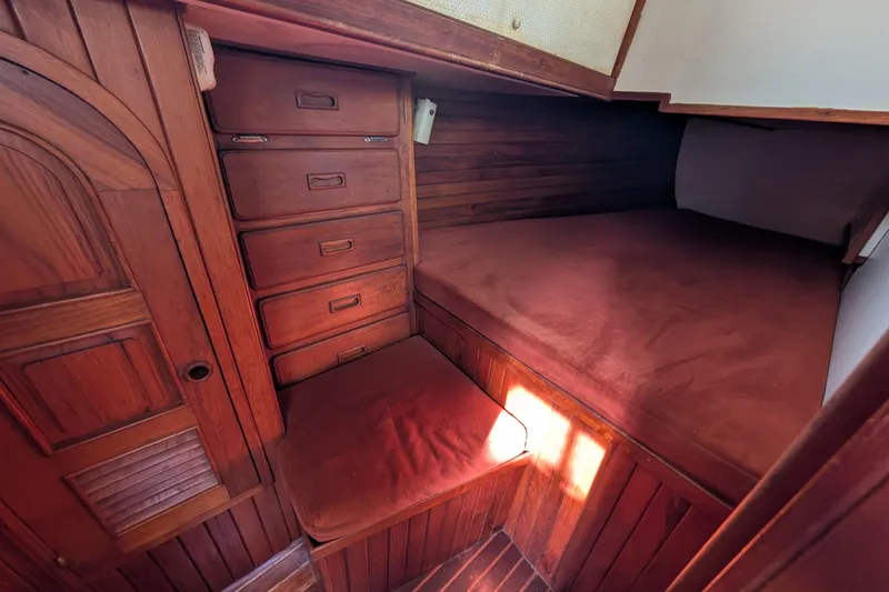 Slide: The Image of Cozy wooden cabin interior of 1983 Robert Perry 41 sailboat with built-in storage. - 29