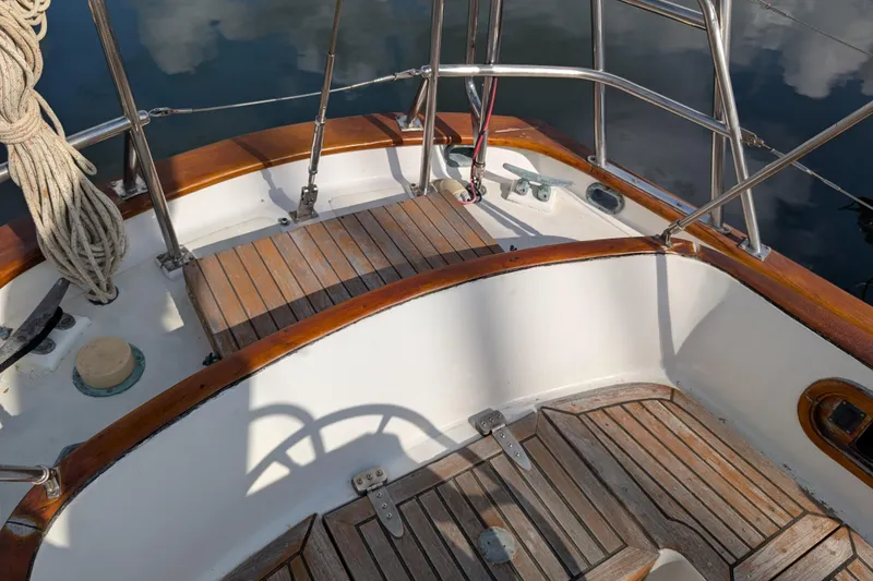 Slide: The Image of Cockpit of 1983 Robert Perry 41 sailboat with wooden deck and stainless steel railings. - 34