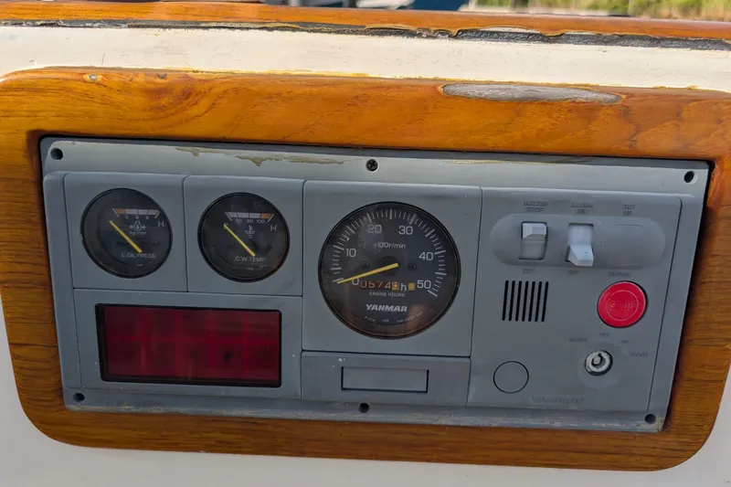 Slide: The Image of Control panel of a 1983 Robert Perry 41 sailboat with Yanmar engine gauges. - 35