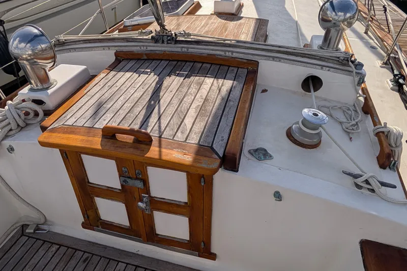 Slide: The Image of 1983 Robert Perry 41 sailboat deck with wooden hatch and winch. - 36