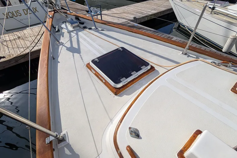 Slide: The Image of Deck of a 1983 Robert Perry 41 sailboat with wooden trim and hatch. - 41