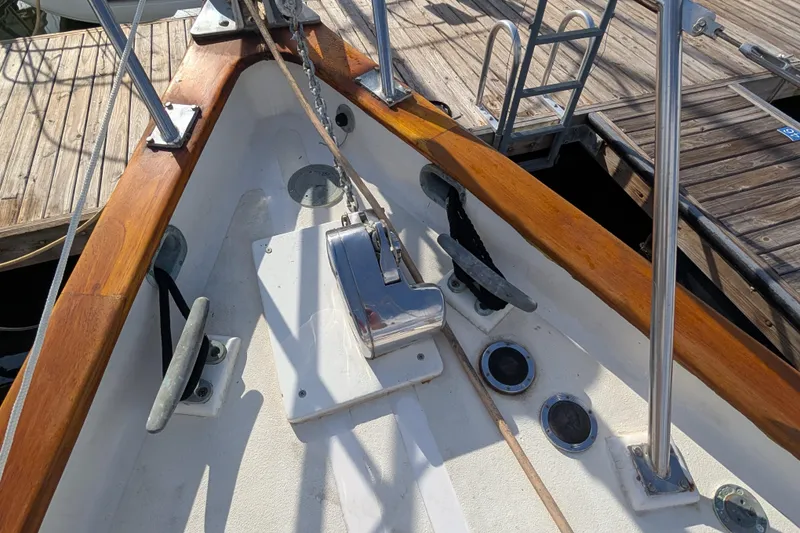 Slide: The Image of Bow of 1983 Robert Perry 41 sailboat with anchor windlass and wooden trim. - 42