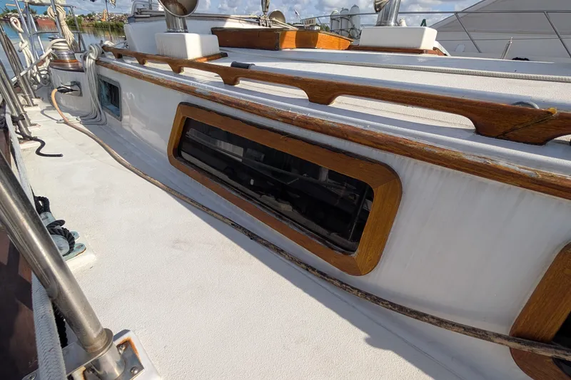 Slide: The Image of 1983 Robert Perry 41 sailboat deck with wooden trim and window detail. - 46