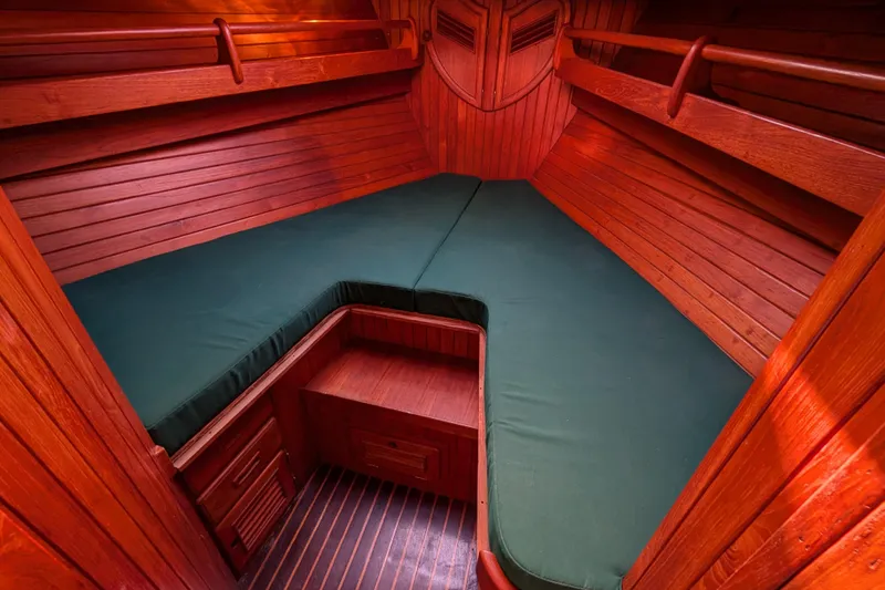 Slide: The Image of Cozy wooden cabin interior of 1983 Robert Perry 41 sailboat with green cushions. - 9