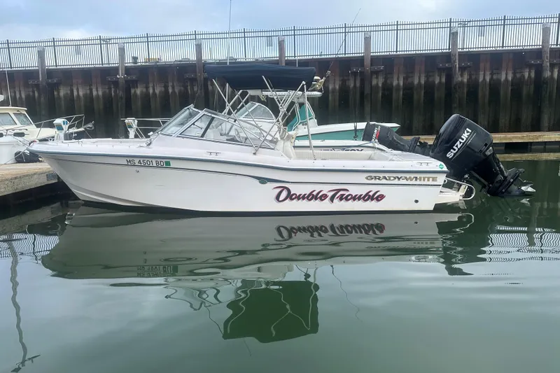 Slide: The Image of 2004 Grady-White Tournament 225 boat docked with Suzuki outboard motor. - 0