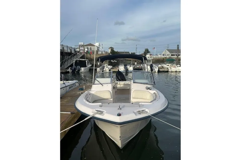 Slide: The Image of 2004 Grady-White Tournament 225 boat docked in a marina, featuring open bow seating. - 1