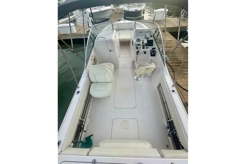 Slide: The Image of 2004 Grady-White Tournament 225 boat interior with seating and steering console. - 15
