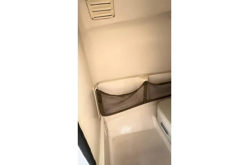 Slide: The Image of Interior of 2004 Grady-White Tournament 225 boat with storage netting. - 19