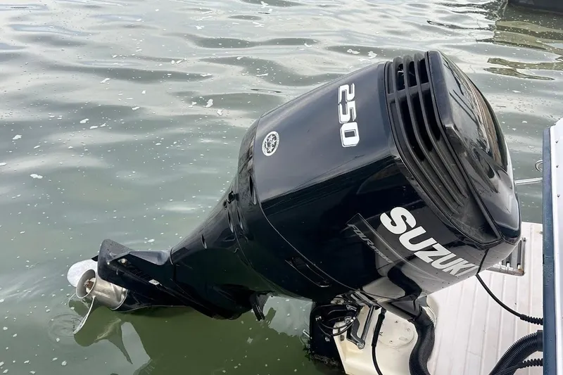 Slide: The Image of Outboard motor on 2004 Grady-White Tournament 225 boat in water. - 2