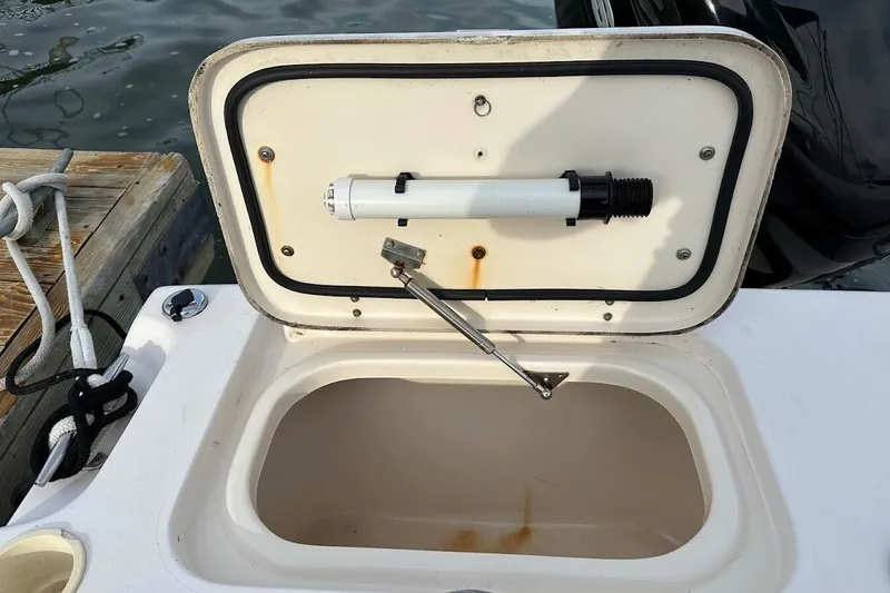 Slide: The Image of Open storage compartment on 2004 Grady-White Tournament 225 boat, dockside view. - 20