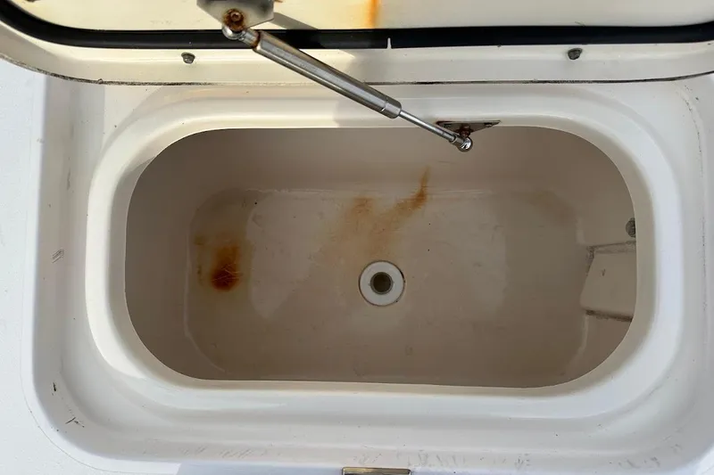Slide: The Image of Open storage compartment on 2004 Grady-White Tournament 225 boat, showing interior stains. - 21