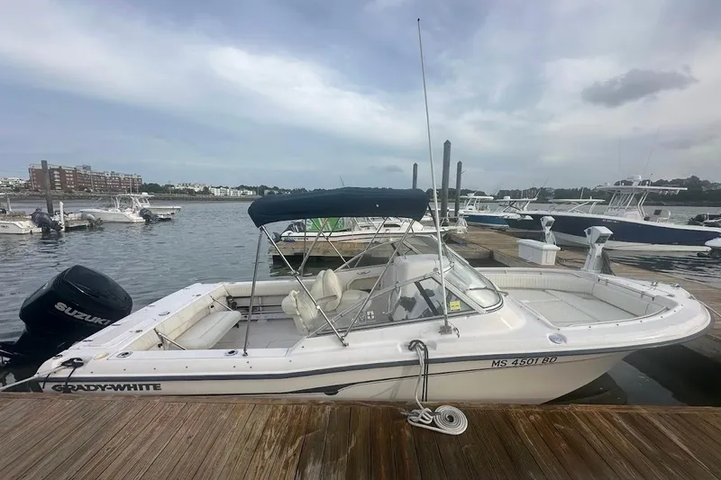 Slide: The Image of 2004 Grady-White Tournament 225 boat docked at marina with Suzuki outboard motor. - 3