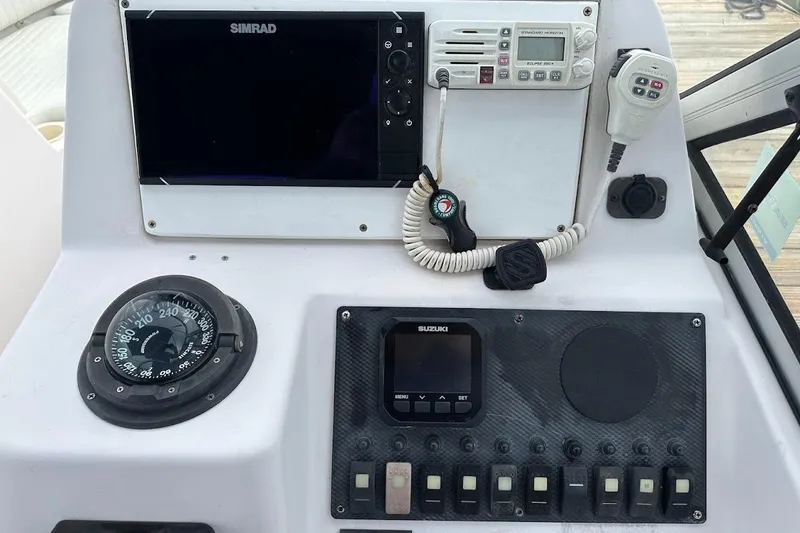Slide: The Image of Control panel of a 2004 Grady-White Tournament 225 boat with navigation instruments. - 4