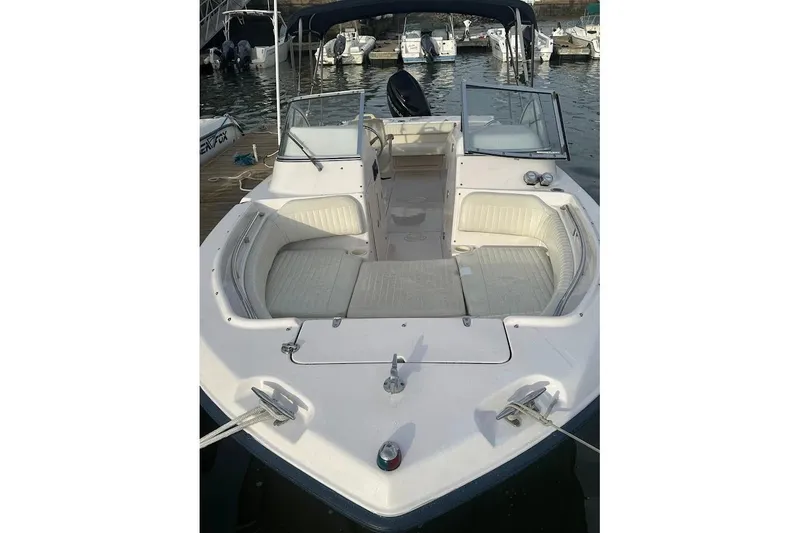 Slide: The Image of 2004 Grady-White Tournament 225 boat with spacious seating, docked at marina. - 7