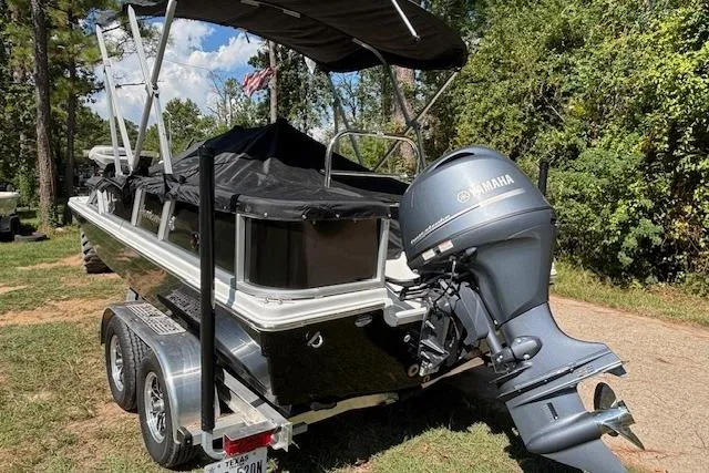 Slide: The Image of 2025 Hurricane FunDeck 198 RE OB boat on trailer with Yamaha outboard motor, parked outdoors. - 5