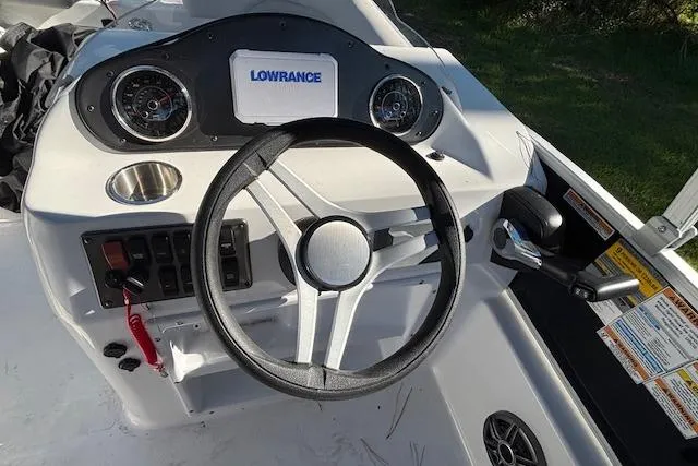 Slide: The Image of Steering console of 2025 Hurricane FunDeck 198 RE OB with Lowrance display and controls. - 7