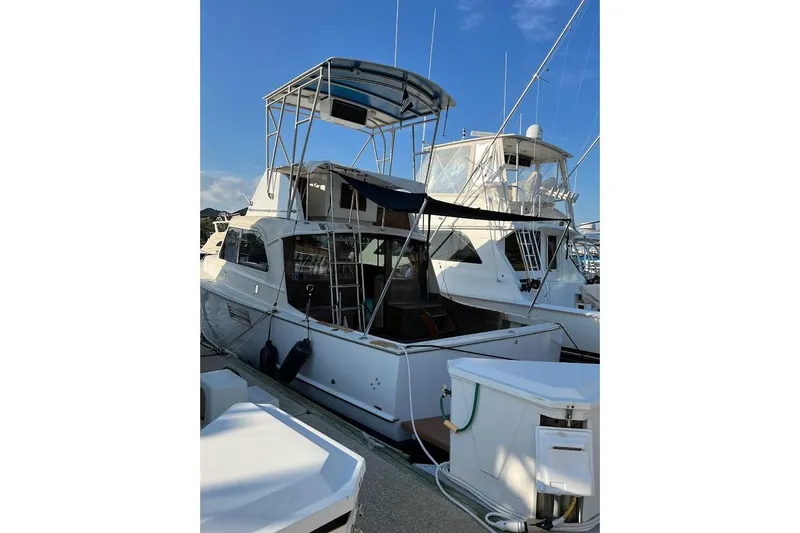 Slide: The Image of 1963 Hatteras 34 Convertible yacht docked at marina under clear blue sky. - 10